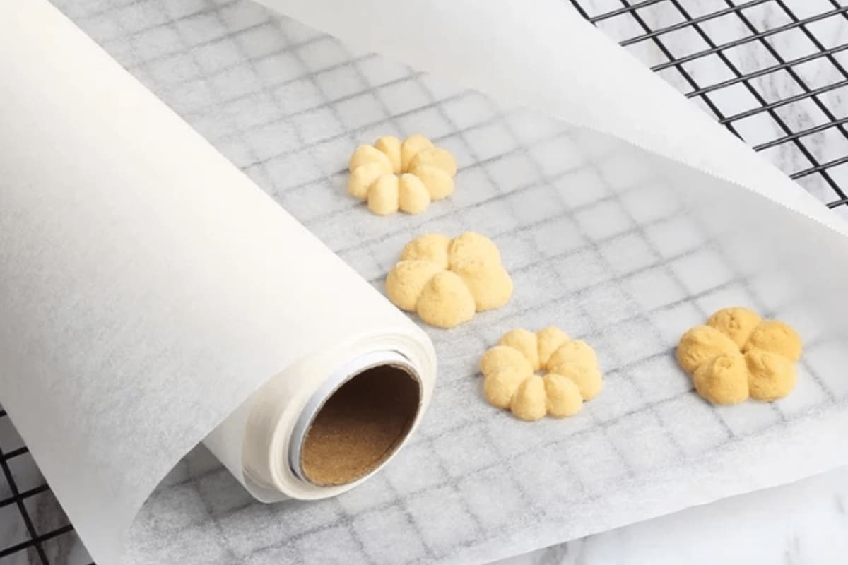 The cookies are placed on the white baking paper.