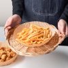round air fryer paper in circular shape with crispy fries on top