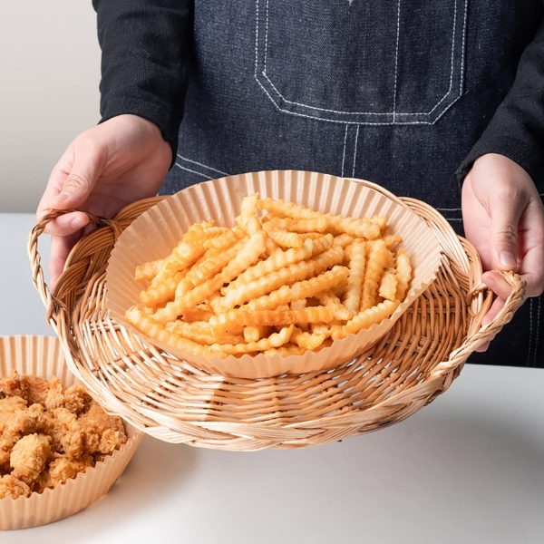 round air fryer paper in circular shape with crispy fries on top