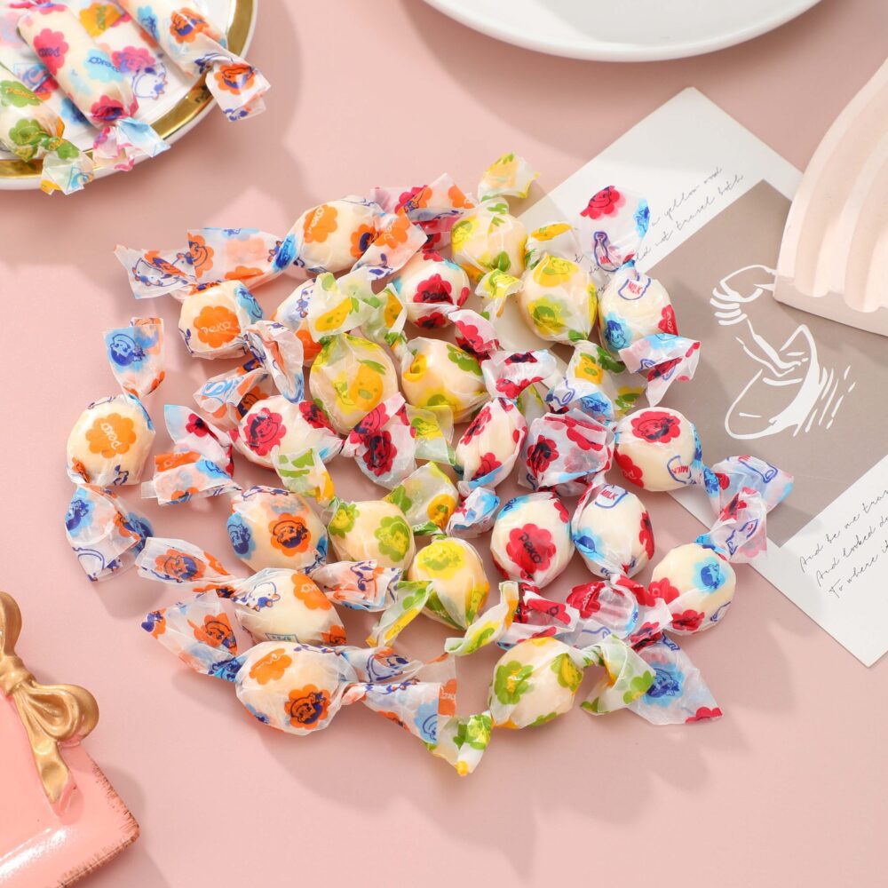 The candies wrapped in candies of different colors are placed on the table.